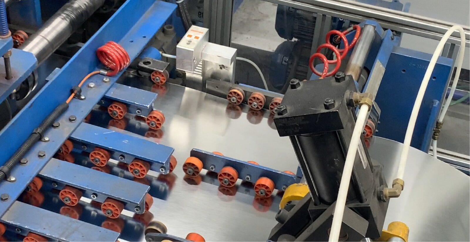 IS1270 MK II installed on the fixed guide of a coil cutting line IS1270 MK II Coil Translation Measurement System installed on the fixed guide assembly of a coil cutting line, over the coil edge alongside the gauging rolls